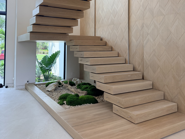 F Stairs team reviewing drawings, fabricating stair components, and installing a custom staircase.